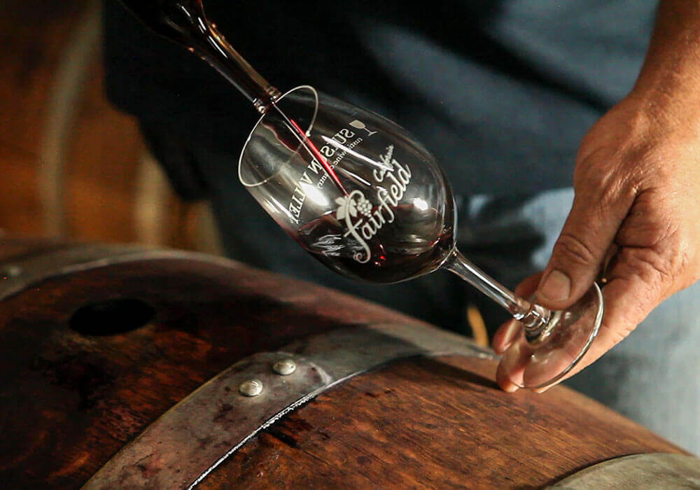A glass of wine being poured